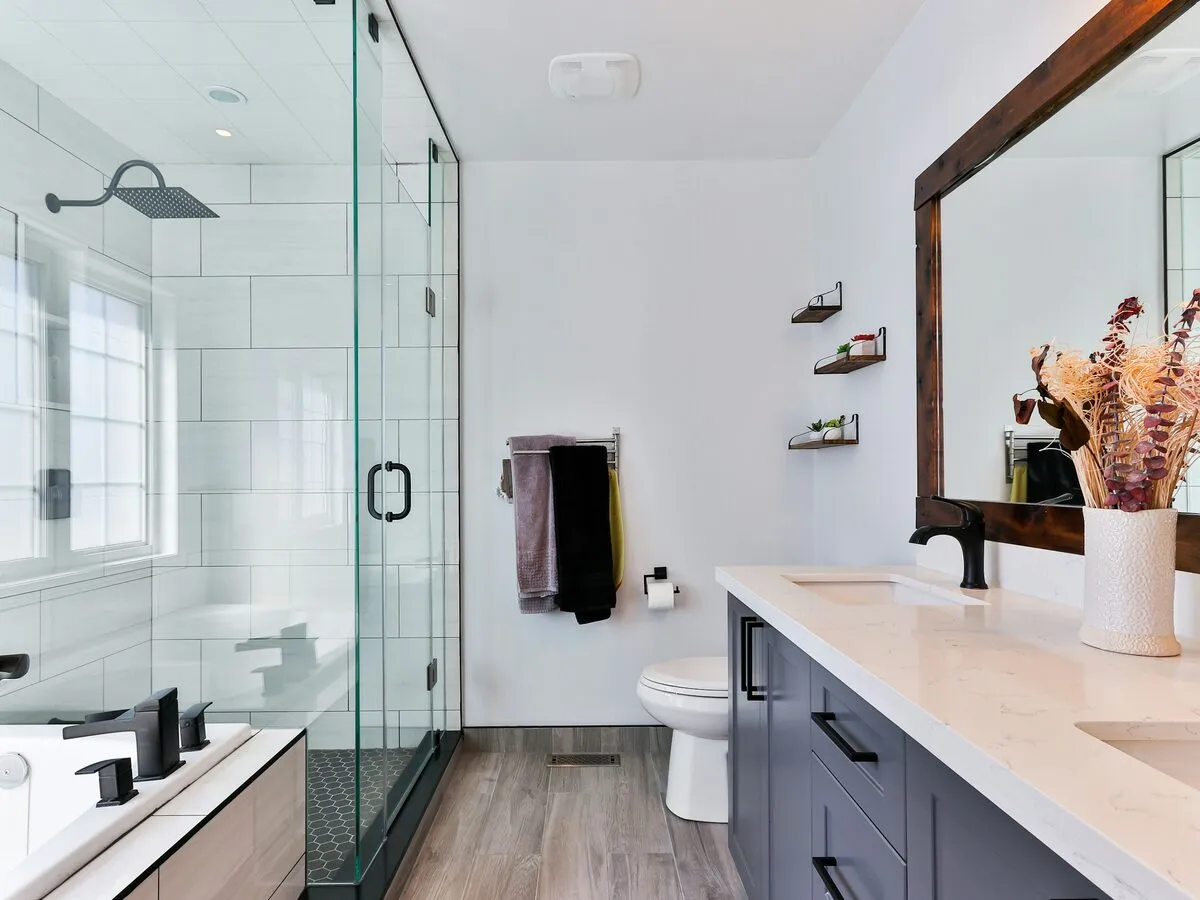 Bright fitted bathroom with a glass shower enclosure and a long vanity unit