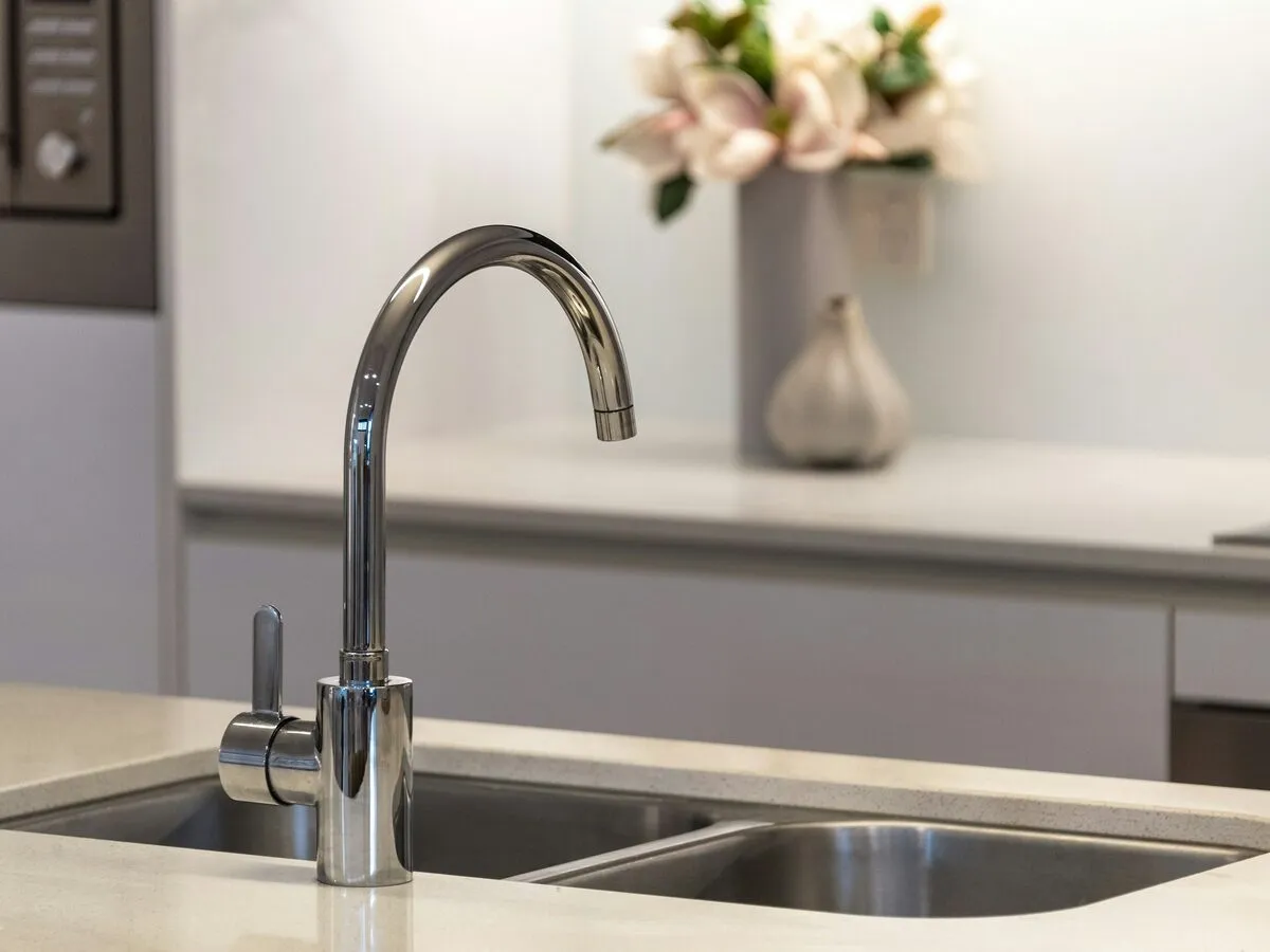 Chrome mixer tap over a stainless steel kitchen sink